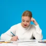 painter-cute-young-blonde-painter-girl-drawing-paper-with-blue-pen_11zon
